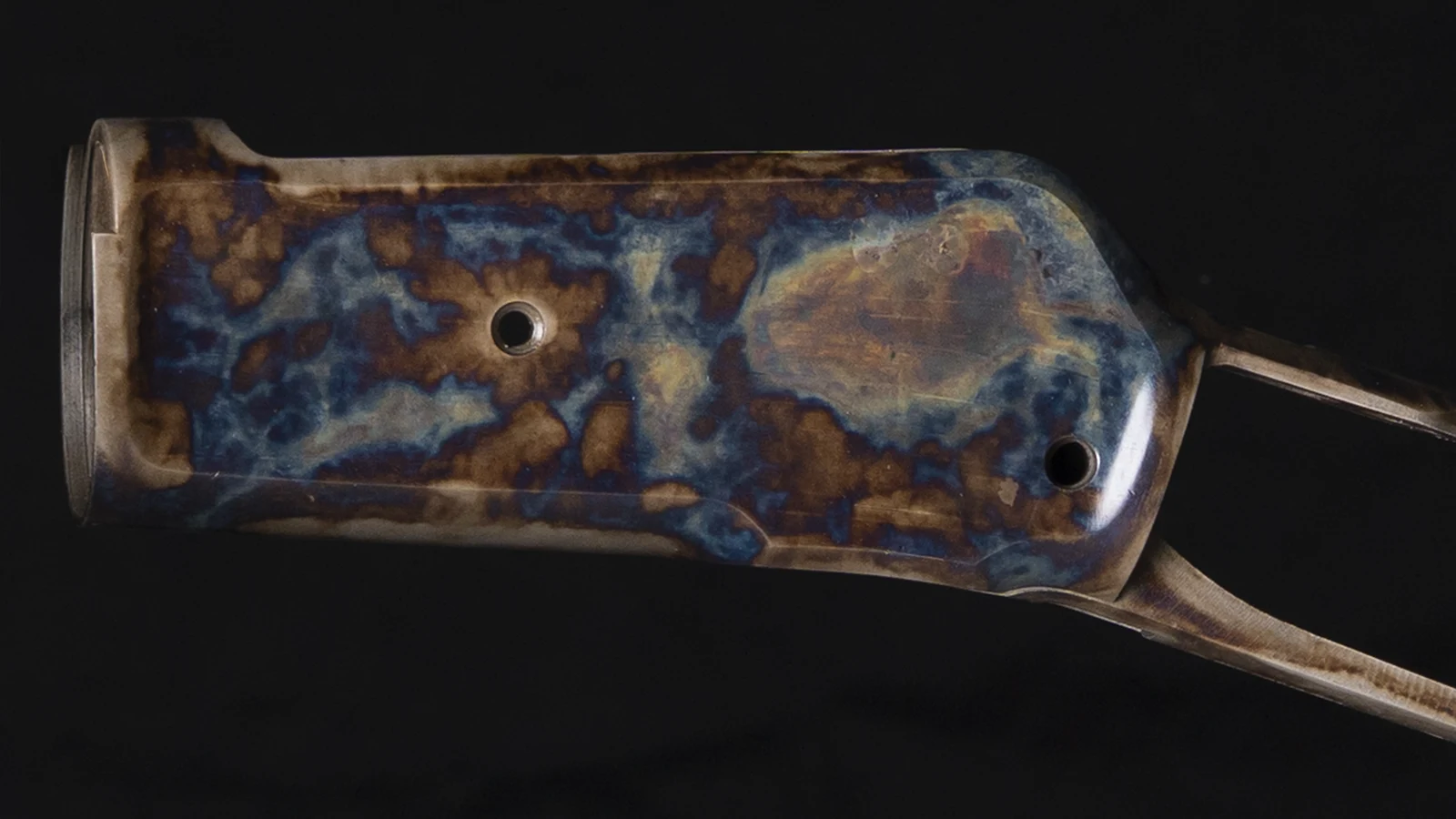 Left side of a Winchester 1886 receiver with bone charcoal color case hardening